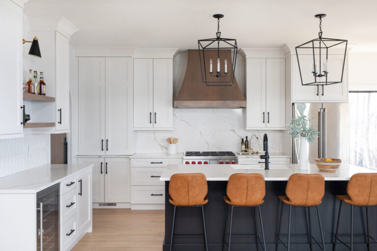 kitchen view hardwood flooring black island with four stools and white tile kitchen backsplash