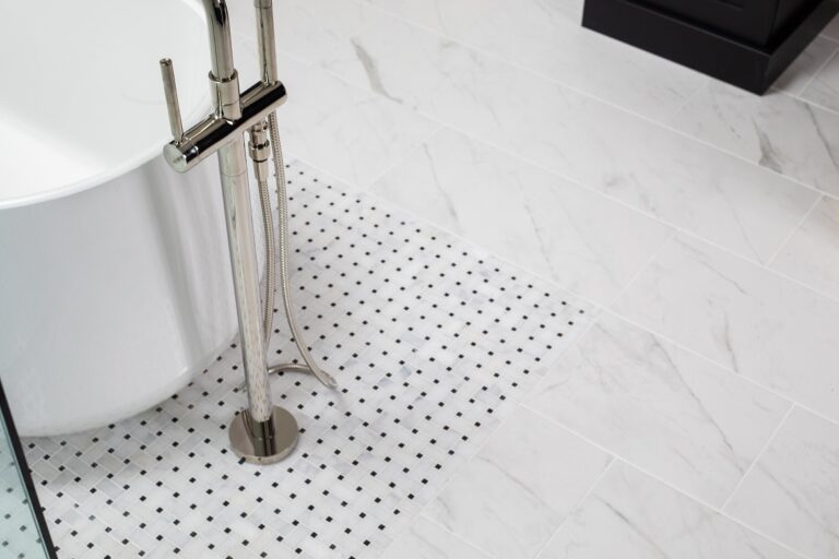 white marble tile floor under white free standing tubs