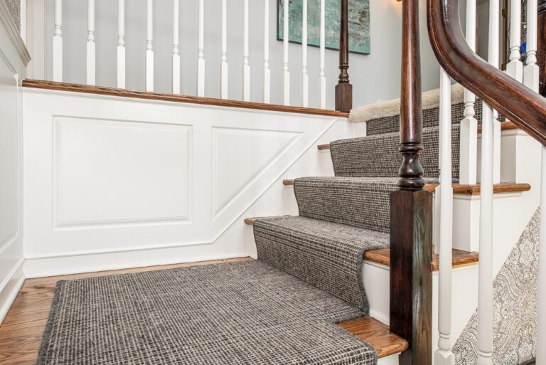 dark plaid carpet stair runner on stairs and hardwood floor landing