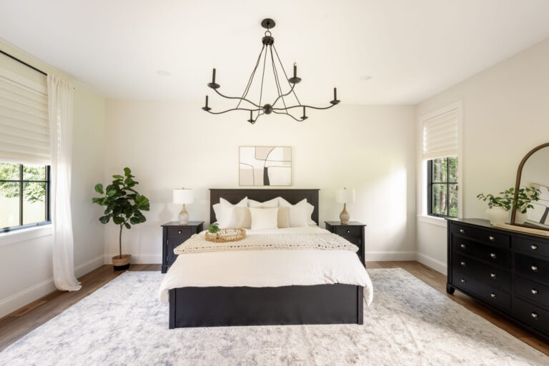 bedroom with queen size bed large area rug and hardwood flooring
