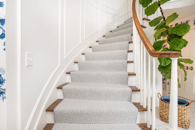 blue pattern carpet stair runner on curved stair case