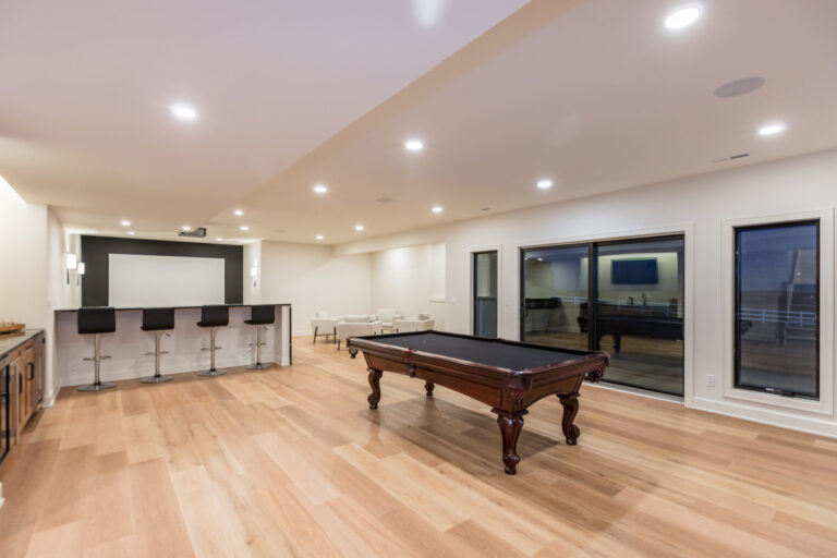 lower level common area with hardwood flooring pool table and large screen tv with seating