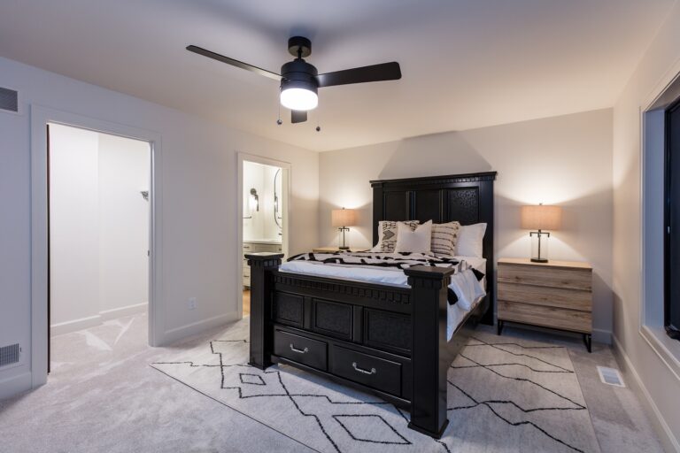 bedroom with wall to wall carpet and area rug under queen size bed