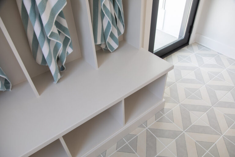 grey and ivory geometric design tile floor in mud room