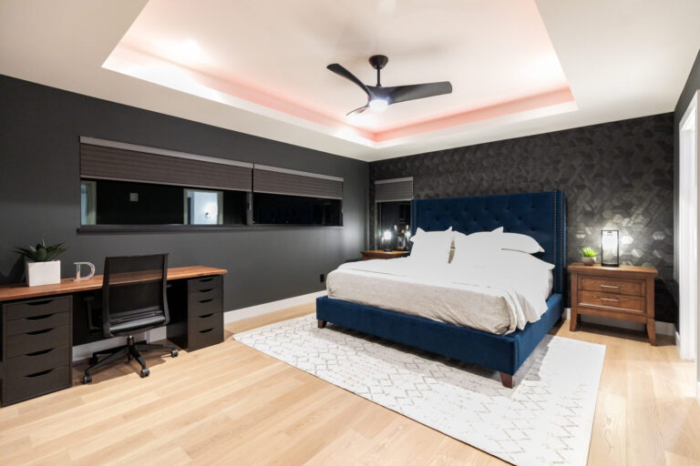 bedroom with queen bed white oak hardwood floor and dark grey wall paint