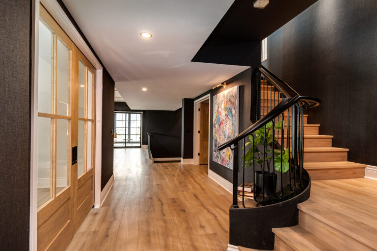 lower level stair case and hallway with luxury vinyl plank wood look floor