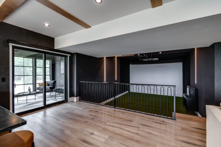 lower level with big screen and seating with upper level luxury vinyl plank wood look floor