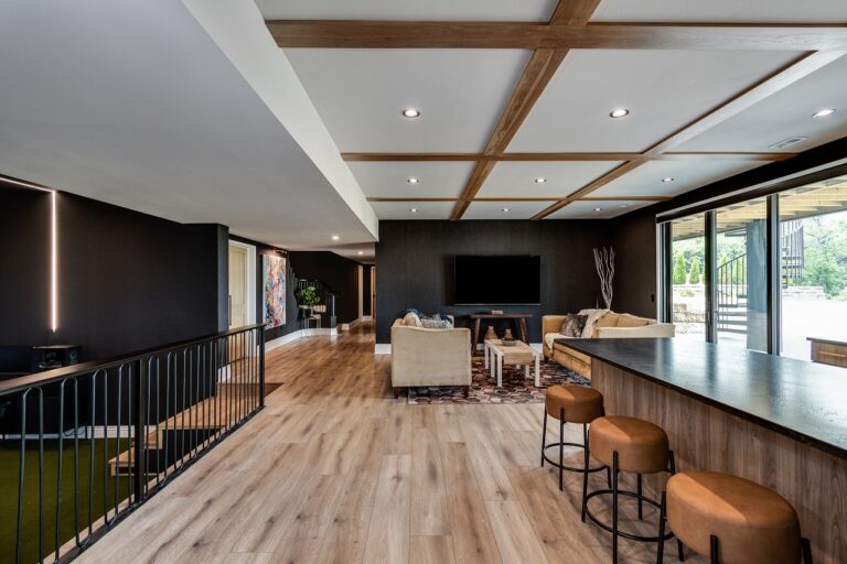 lower level luxury vinyl plank flooring looking at tv area with bar and bar stools on the side