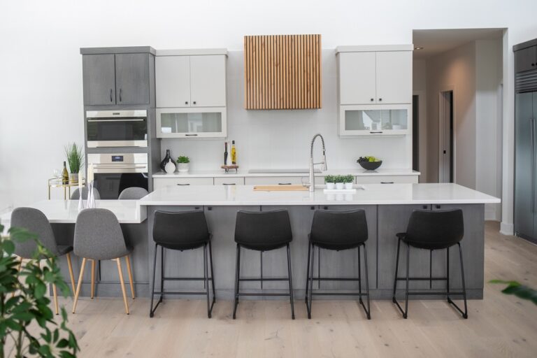 kitchen with grey and white island white oak hardwood floor and floating cabinets