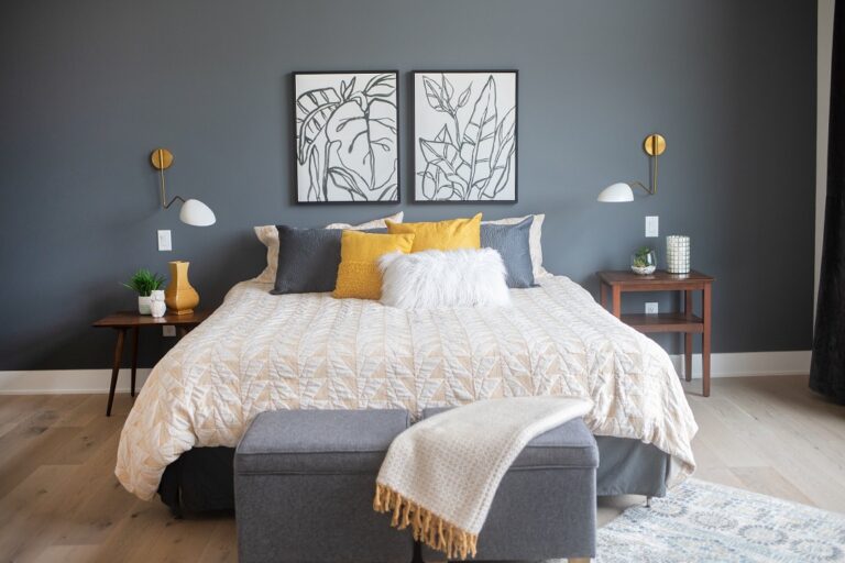 bedroom with light hardwood floors and a queen size bed with dark color walls