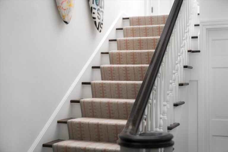 red stripe and beige color carpet stair runner white and wood railing