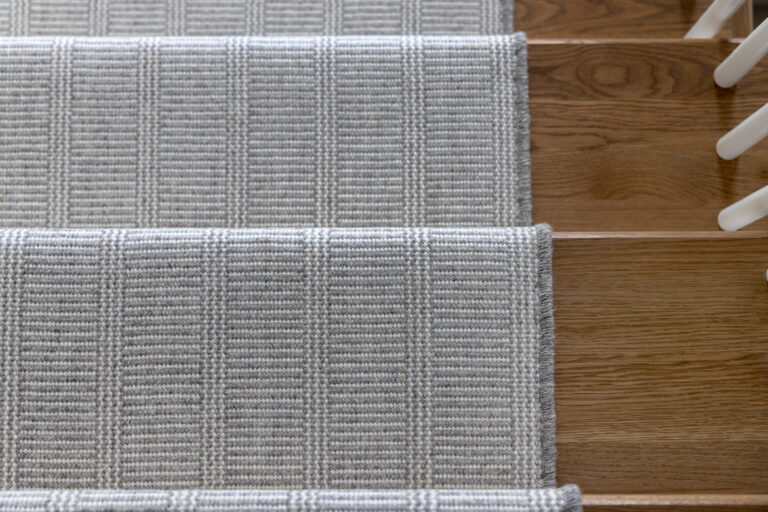 grey carpeting stair runner on hardwood stairs