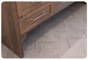 Herringbone pattern tile in warm neutral tones in a Madison home, highlighting 2026 tile trends.