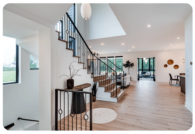 view inside a home with wood look luxury vinyl plank flooring and a staircase leading to the second level wall color is white