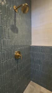 inside walk in shower vertical green teal zellige tile shower wall
