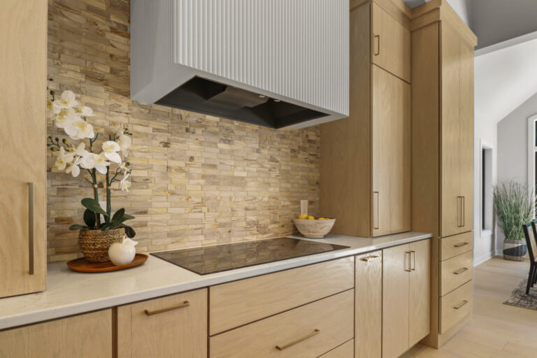 brown cream and tan stone look tile kitchen backsplash above the stove