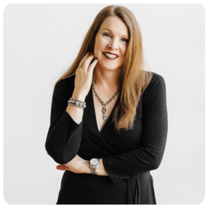 Kelly Kuehn headshot in black blazer