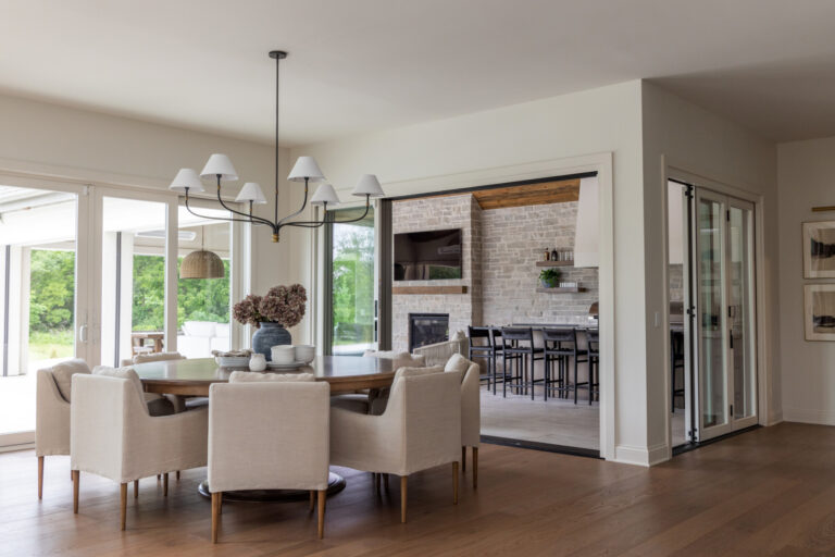 hardwood floor in open concept living area leading to cabana room with grey tile floor