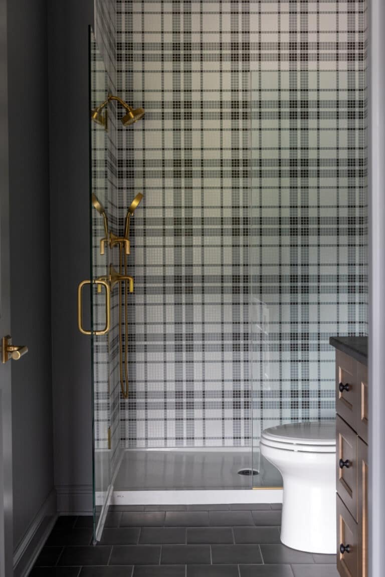 walk in shower with black and white plaid tile shower wall