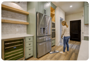 bright kitchen with luxury vinyl plank flooring being cleaned with a microfiber mop