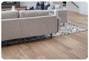 Light natural engineered hardwood flooring in a Madison, Wisconsin living room with layered area rug