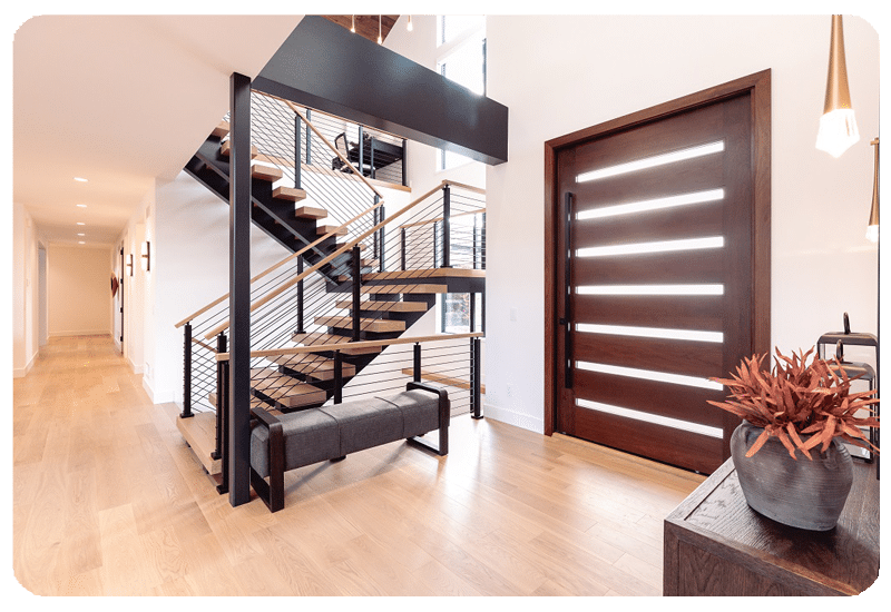 Sunny hardwood floored entryway with stairs