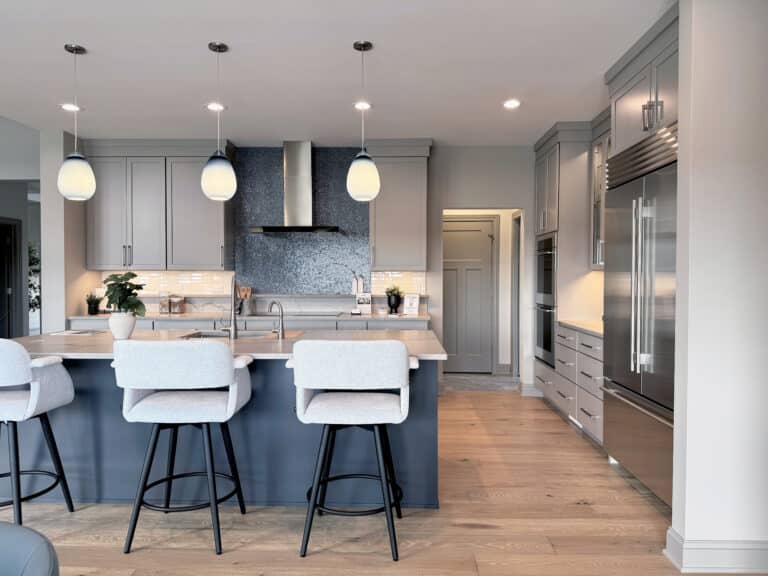 kitchen with hardwood and blue mosaic tile above the stove