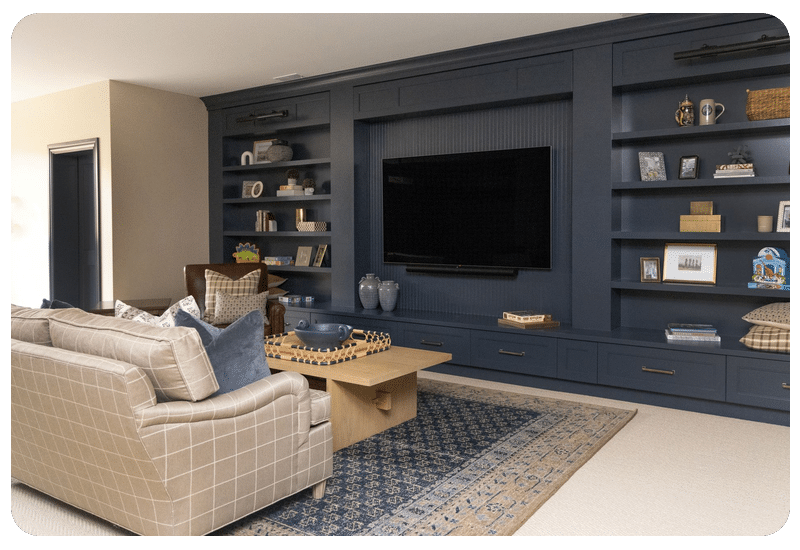 Cozy family room with carpet, patterned area rug and navy built-ins, a space where warm floors make winter more comfortable