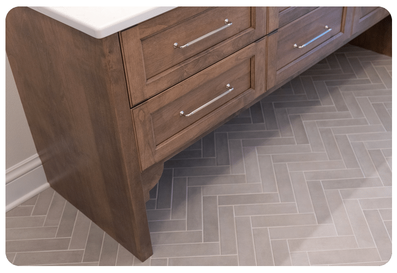 Herringbone tile floor beside warm wood cabinetry, the kind of tile floor often paired with radiant floor heating
